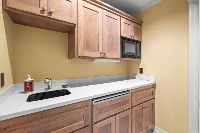 kitchen featuring crown molding, sink, and black microwave