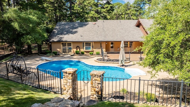 view of pool featuring a diving board and a patio