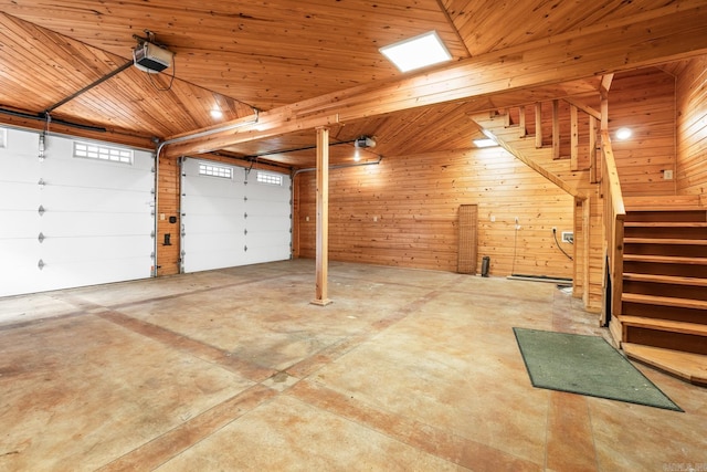 garage with a garage door opener, wood ceiling, and wood walls