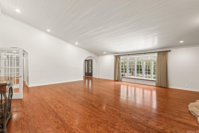 unfurnished living room featuring hardwood / wood-style floors, wooden ceiling, and ornamental molding