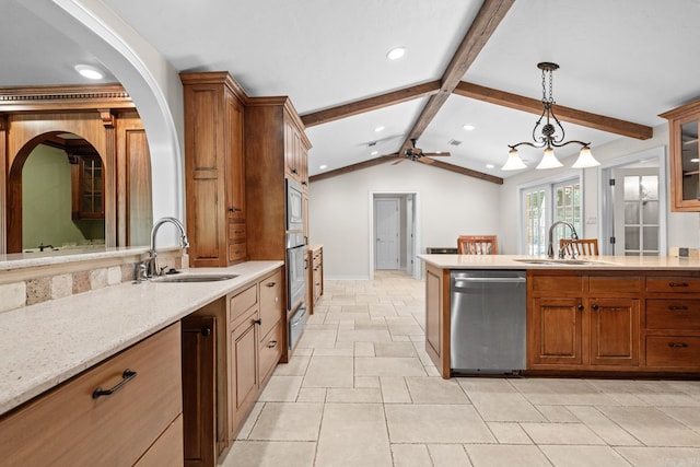 kitchen with appliances with stainless steel finishes, vaulted ceiling with beams, ceiling fan, and sink