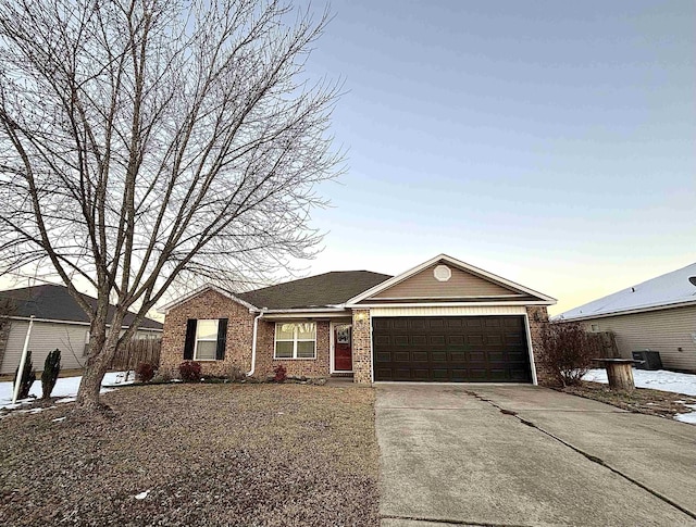 single story home featuring central AC and a garage