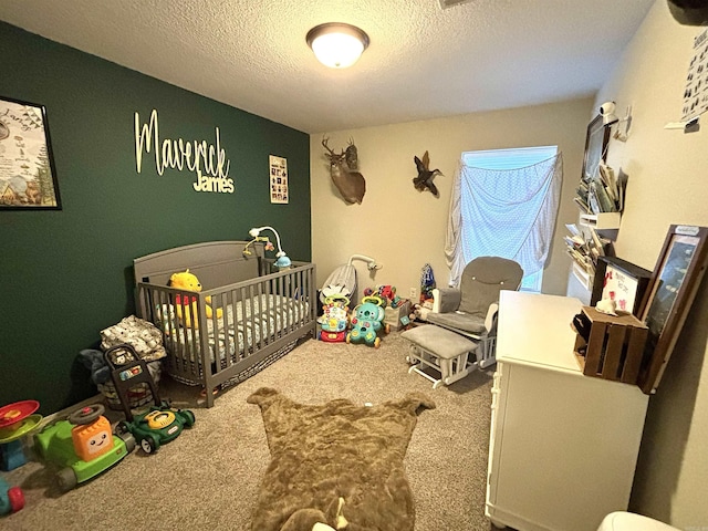 bedroom with carpet, a textured ceiling, and a nursery area