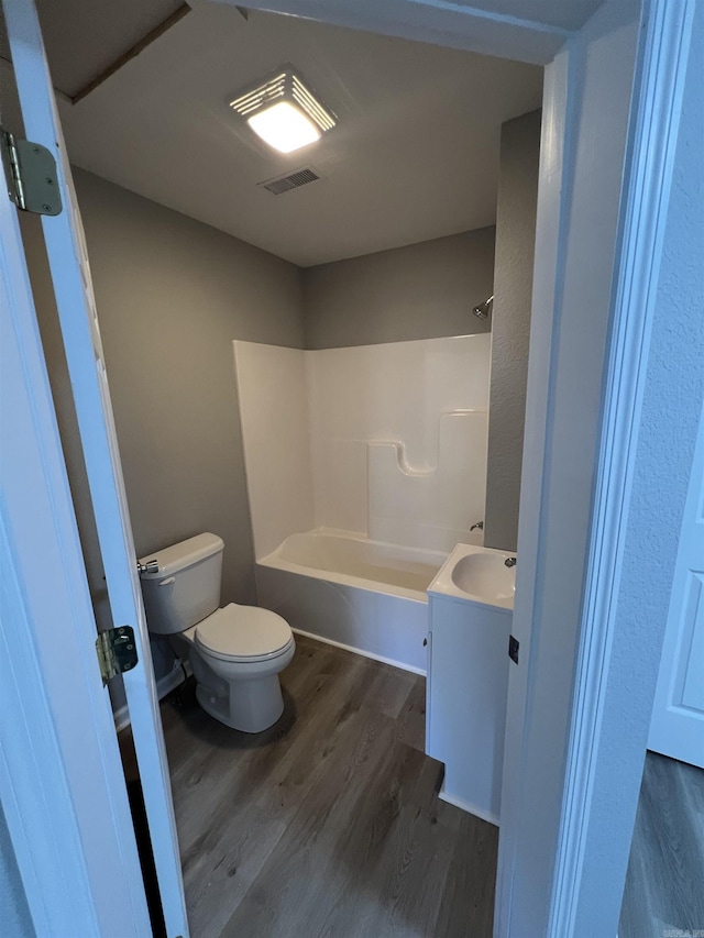 full bathroom with vanity, toilet, wood-type flooring, and bathtub / shower combination