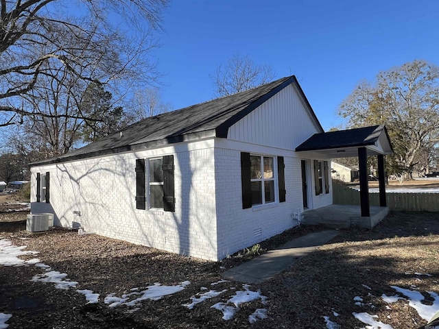 snow covered property featuring central AC unit