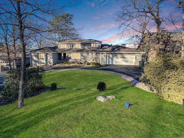 prairie-style home featuring a yard and a garage