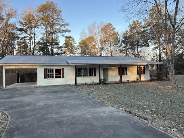 single story home with a front yard and a carport