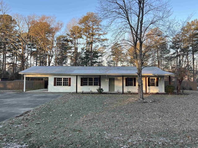 ranch-style home featuring a carport