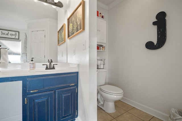 bathroom featuring toilet, crown molding, tile patterned flooring, baseboards, and vanity