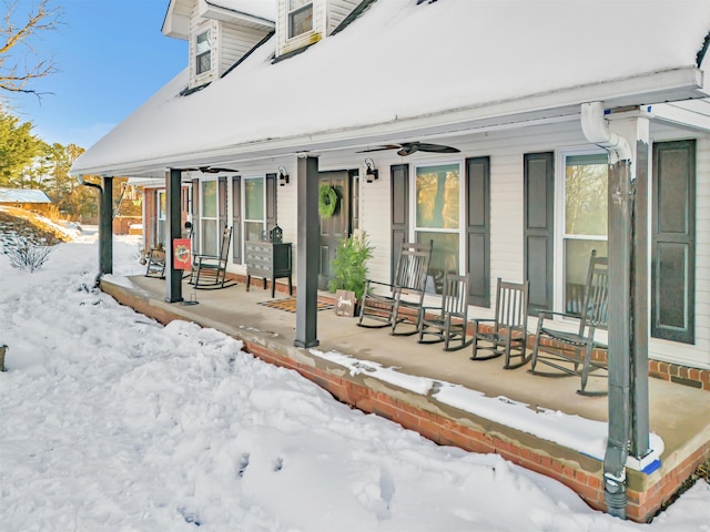 snow covered patio with covered porch and ceiling fan