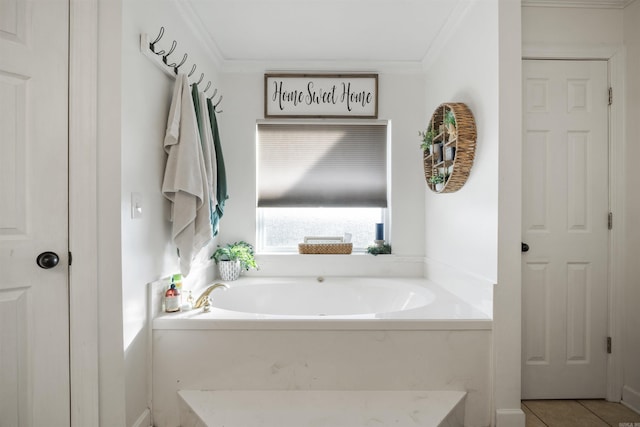 bathroom with tile patterned floors, crown molding, and a garden tub