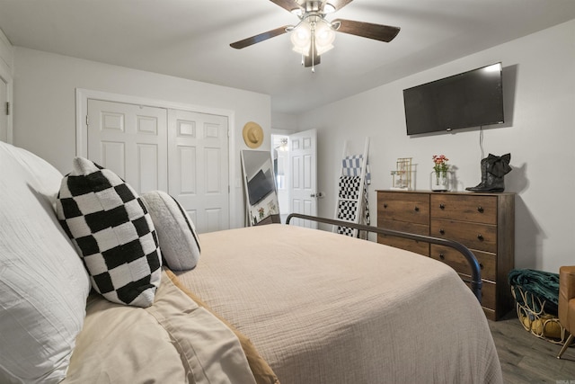 bedroom featuring ceiling fan, a closet, and dark wood-style floors