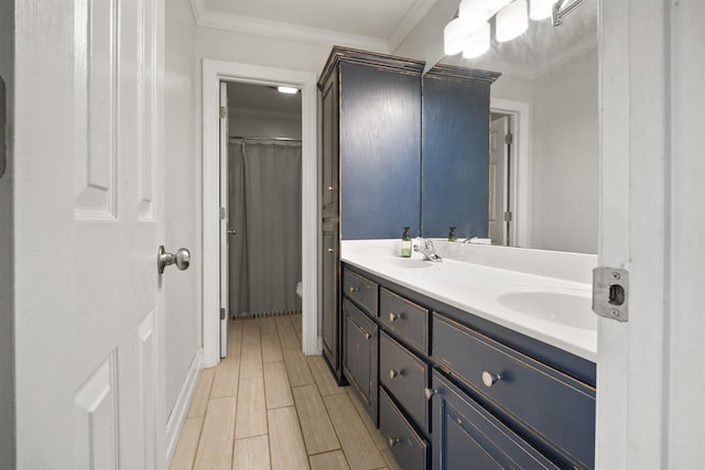 full bathroom with crown molding, toilet, double vanity, and a sink