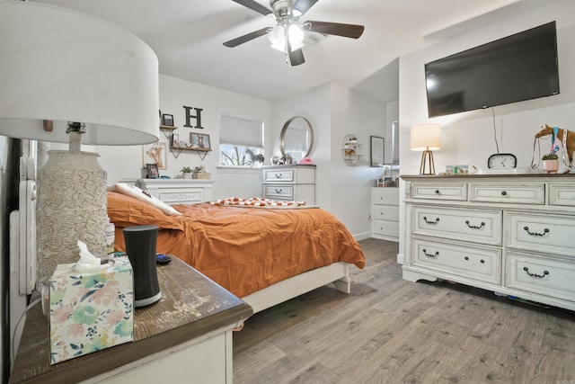 bedroom with ceiling fan and light wood-type flooring