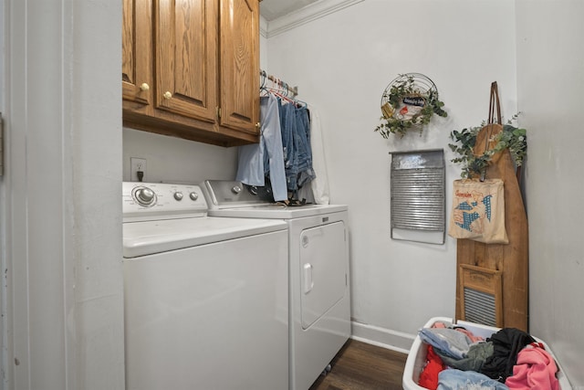 laundry area featuring crown molding, baseboards, dark wood-type flooring, cabinet space, and independent washer and dryer