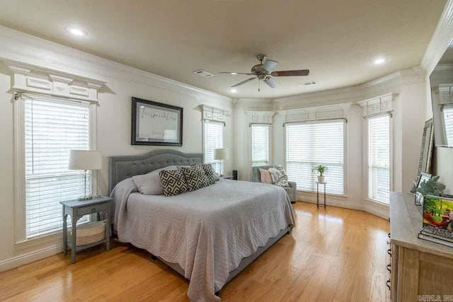 bedroom featuring ceiling fan, light hardwood / wood-style flooring, and ornamental molding