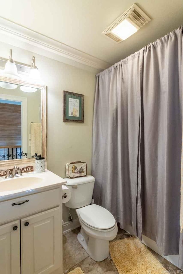 bathroom with vanity, toilet, and crown molding