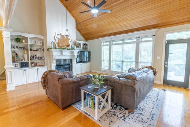 living room featuring vaulted ceiling, light hardwood / wood-style flooring, ceiling fan, and wooden ceiling