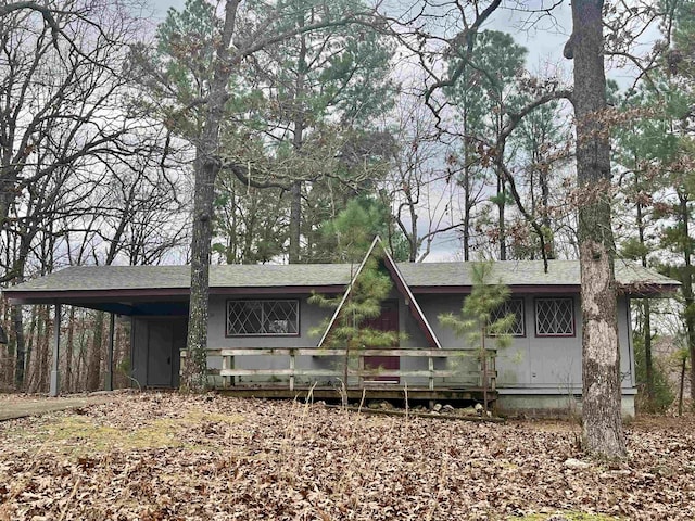 rear view of property featuring a carport