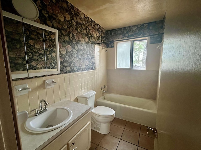 full bathroom featuring vanity,  shower combination, tile walls, tile patterned flooring, and toilet