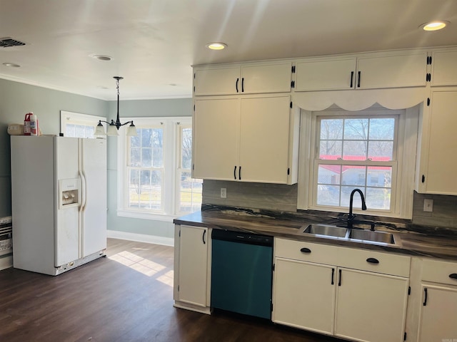 kitchen featuring dishwasher, sink, decorative backsplash, white fridge with ice dispenser, and a chandelier