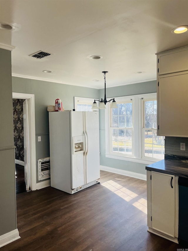 kitchen featuring heating unit, decorative light fixtures, an inviting chandelier, hardwood / wood-style floors, and white fridge with ice dispenser