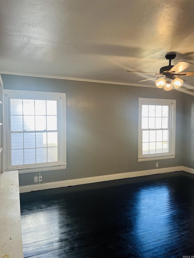 unfurnished room featuring a textured ceiling, plenty of natural light, ceiling fan, and ornamental molding