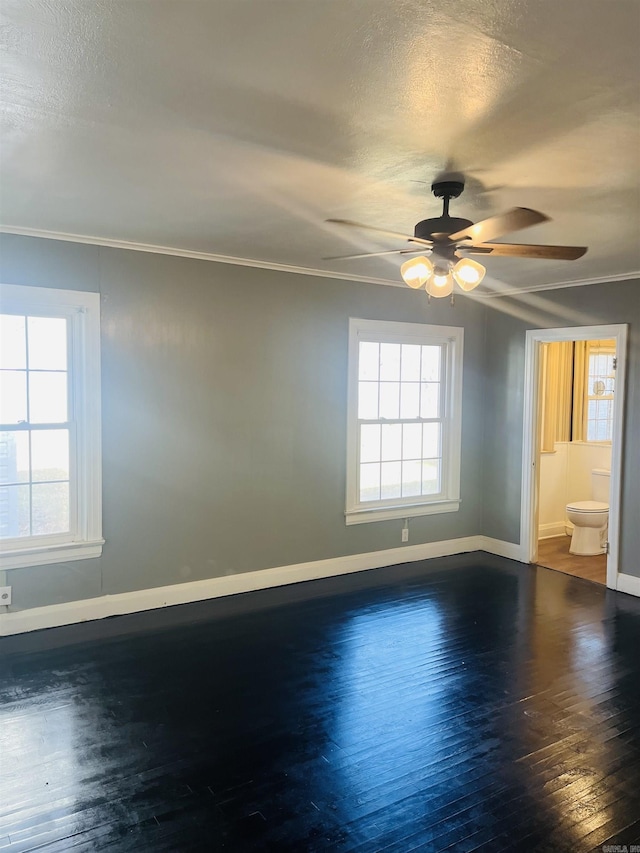 spare room featuring hardwood / wood-style flooring, ceiling fan, crown molding, and a textured ceiling