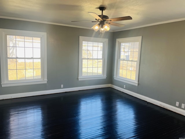 empty room with crown molding, ceiling fan, and dark hardwood / wood-style floors