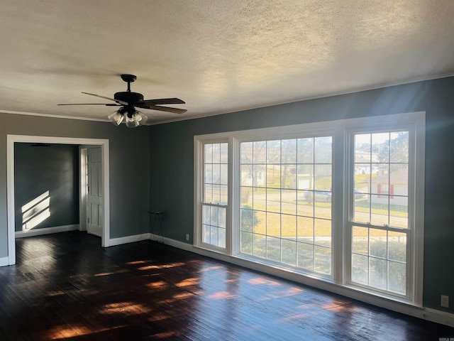 unfurnished room featuring ceiling fan, dark hardwood / wood-style flooring, a textured ceiling, and ornamental molding