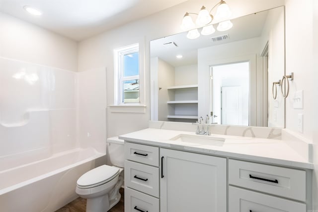 full bathroom featuring washtub / shower combination, vanity, hardwood / wood-style flooring, and toilet