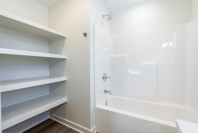 bathroom featuring wood-type flooring and bathing tub / shower combination