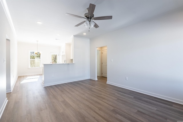 unfurnished living room featuring ceiling fan and hardwood / wood-style flooring