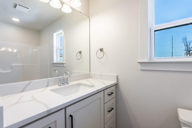 bathroom featuring vanity and toilet