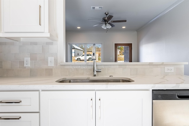 kitchen featuring white cabinetry, sink, stainless steel dishwasher, and ornamental molding