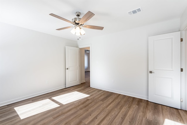 empty room featuring wood-type flooring and ceiling fan