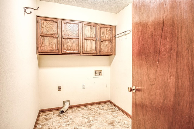 washroom featuring washer hookup, cabinets, hookup for an electric dryer, and a textured ceiling