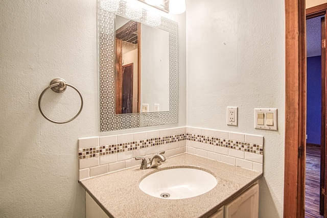 bathroom with vanity and decorative backsplash