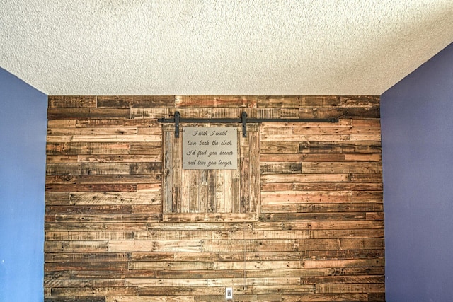 details with a textured ceiling and wooden walls