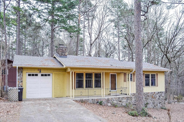 ranch-style home featuring a porch and a garage