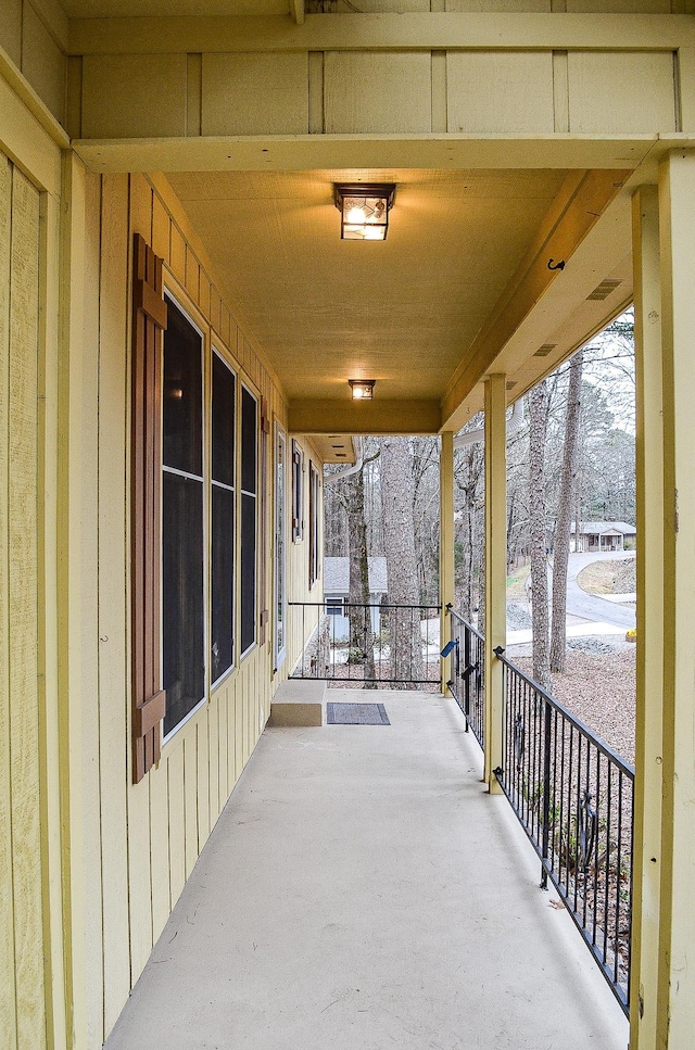 snow covered patio with a porch