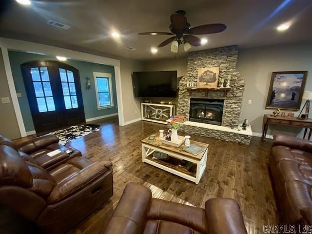 living room with hardwood / wood-style floors, ceiling fan, a fireplace, and french doors