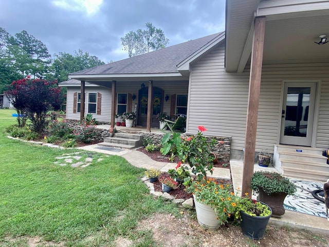 back of property featuring a lawn and a porch