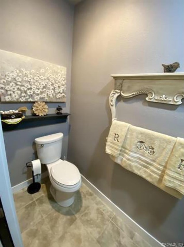 bathroom with tile patterned floors and toilet