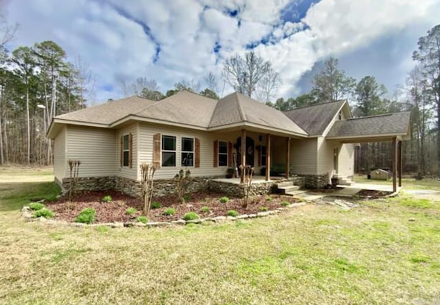 view of front of home with a front yard and a patio