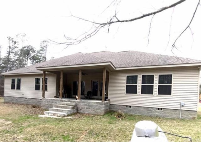 back of house featuring a patio area and a lawn