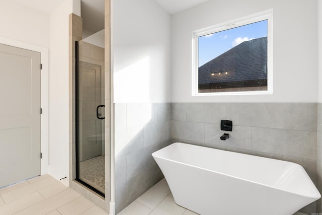 bathroom featuring tile patterned flooring and plus walk in shower