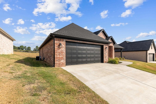 view of front of house with a front yard, a garage, and cooling unit