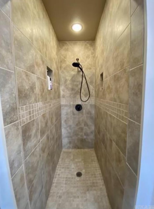 bathroom with tiled shower