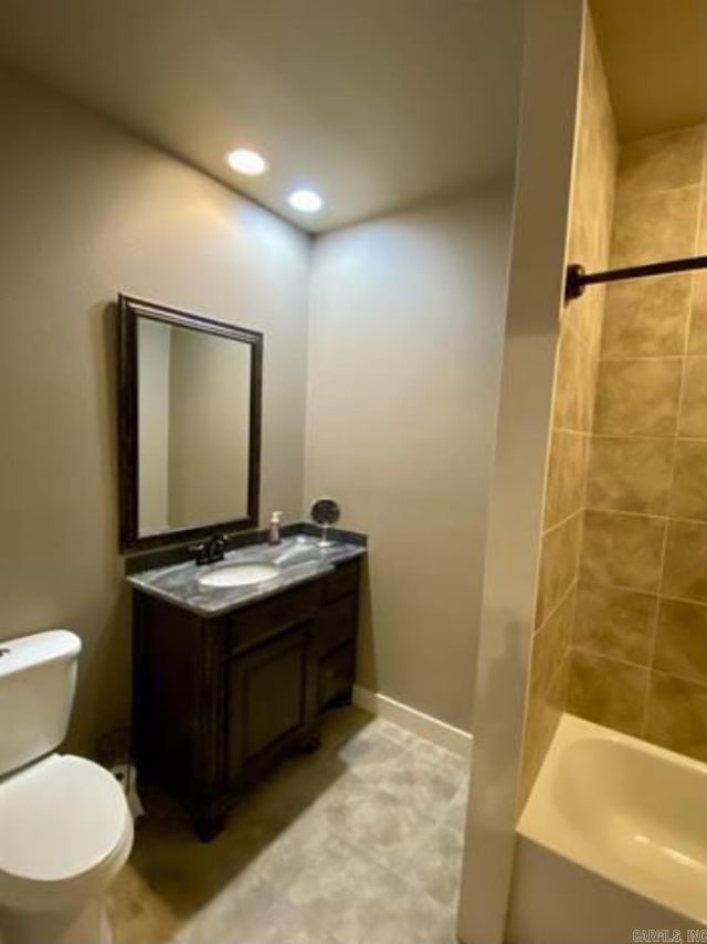 full bathroom featuring vanity, toilet, and tiled shower / bath